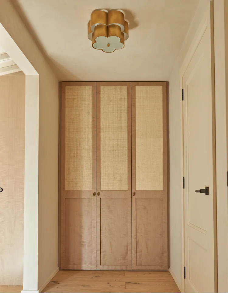 Timber doors below a sculptural ceiling light