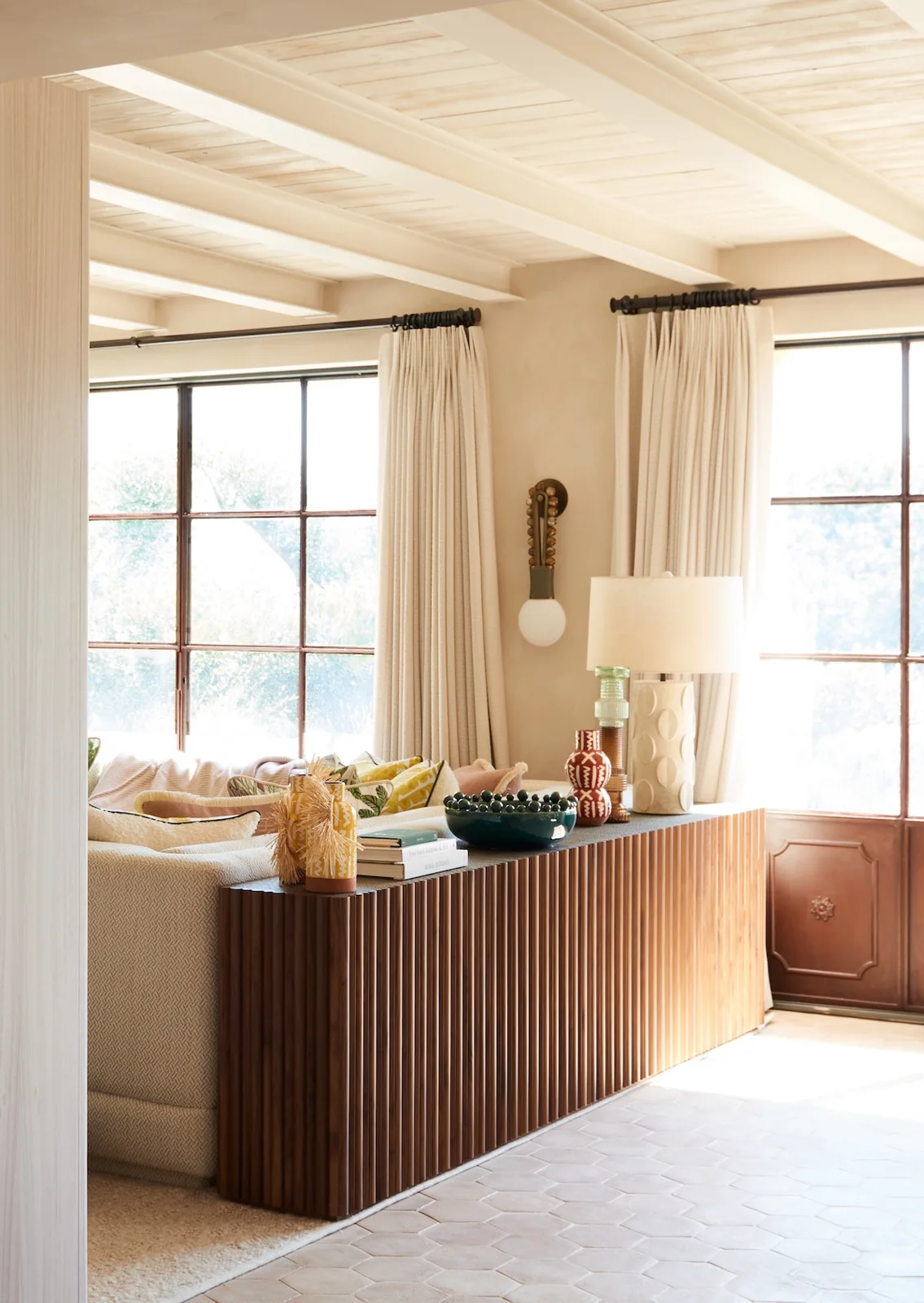 Light falling across a room with timber beams